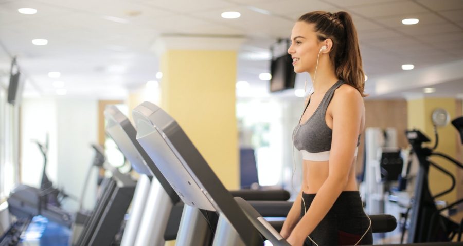 Smiling woman walking on a treadmill