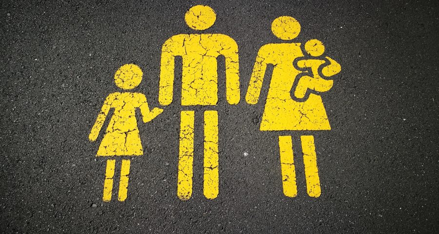 Symbol of a family painted in yellow on the street asphalt