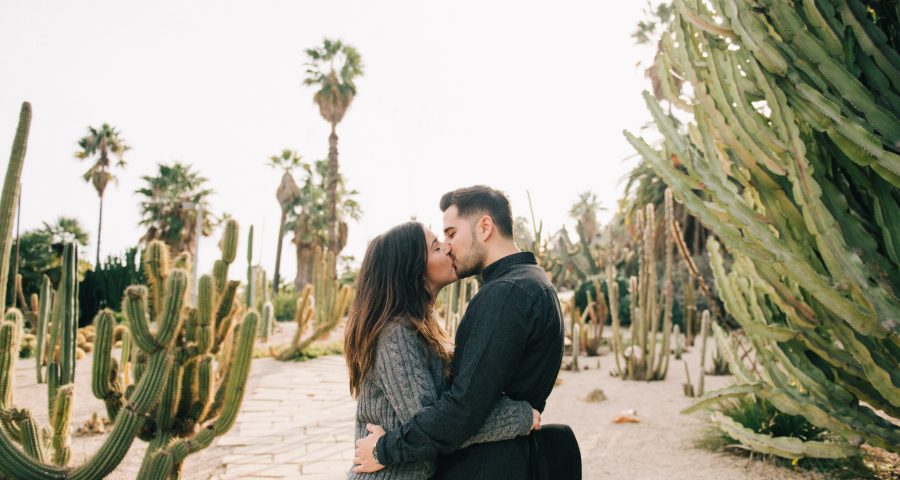Couple kissing in a cactus field